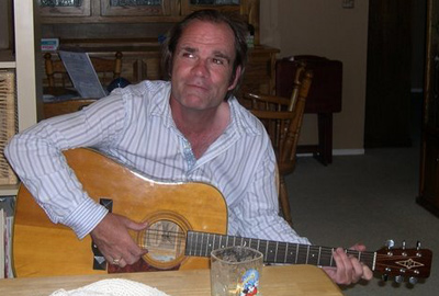 Don Haley playing the guitar at home